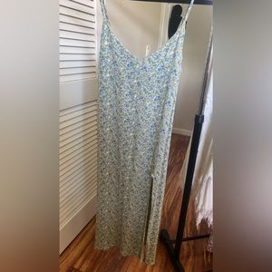 Reformation mid length green dress with slit.